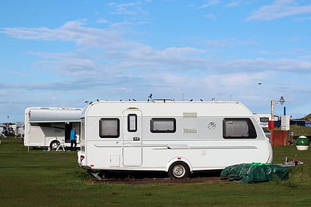 white and gray camping trailer outdoors thumbnail