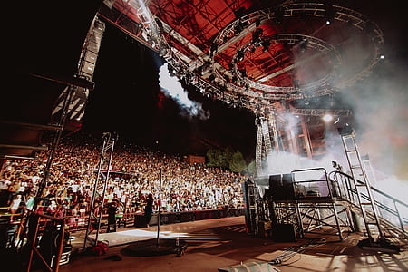 band performing on stage front of people thumbnail