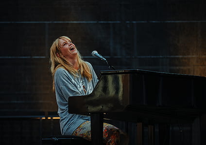 woman singing while playing piano thumbnail