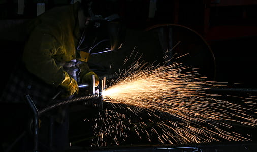 person cutting metal inside room thumbnail