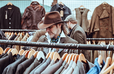 man standing in front of assorted-color suit jacket lot thumbnail