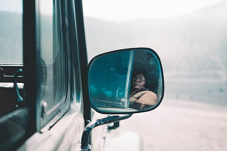 person looking at the side mirror thumbnail