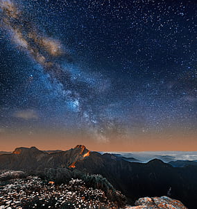 mountain under starry night sky thumbnail