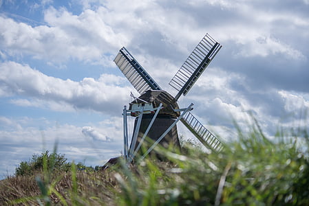 brown windmill in grass field thumbnail
