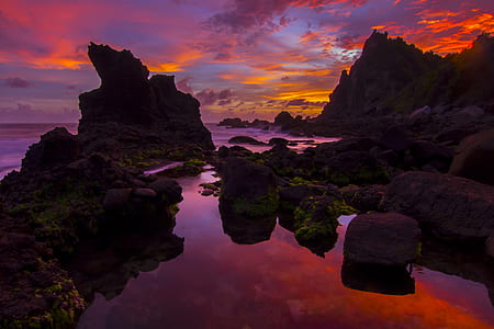 rock formations on sea during dusk thumbnail