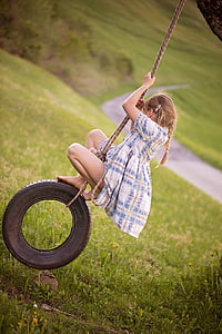 girl riding on black wheel swing thumbnail