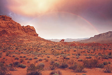 rainbow across valley during golden hour thumbnail