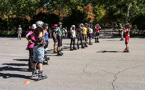 people standing wearing inline skates on gray concrete surface thumbnail