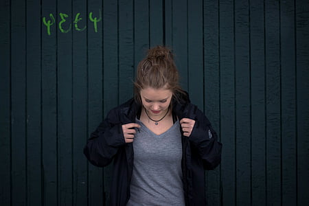 woman wearing gray V-neck shirt and black zip-up hoodie thumbnail