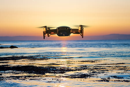 brown quadcopter flying during sunset thumbnail