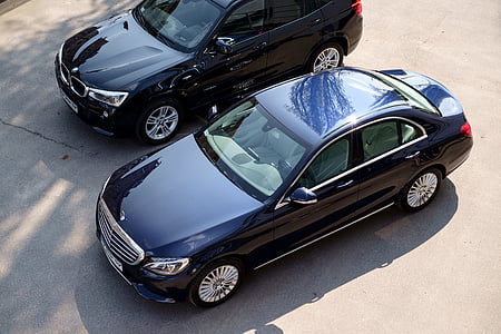 black BMW car and black Mercedes-Benz S-class sedan on parking lot thumbnail