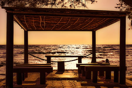 sepia photography of gazebo near ocean thumbnail