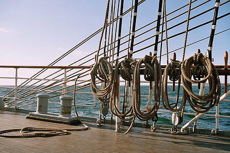 beige ropes near white ship rail thumbnail