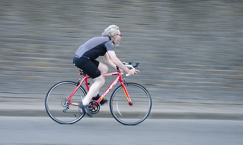 timelapse photography of man riding red road bike thumbnail