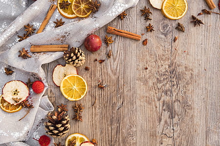 sliced citrus fruits and cinnamon rolls on brown wooden surface thumbnail