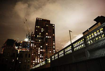 photo of black concrete building under white clouds at daytime thumbnail