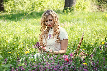 woman sitting on green grass thumbnail
