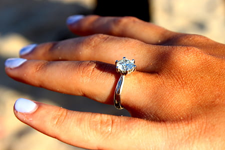 person wearing clear gemstone silver-colored ring thumbnail