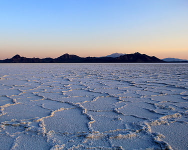 ground covered with snow near mountains thumbnail