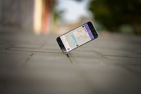 cracked black smartphone on asphalt stone thumbnail