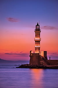 person standing near lighthouse thumbnail