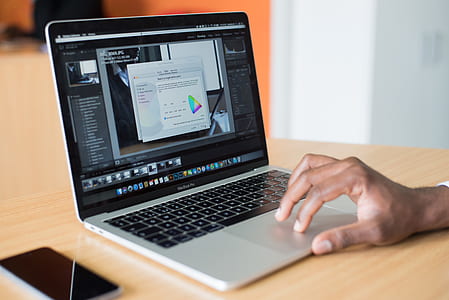 person operating MacBook Pro thumbnail