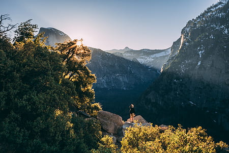 person stands in stone Yellowstone National Park at daytime thumbnail