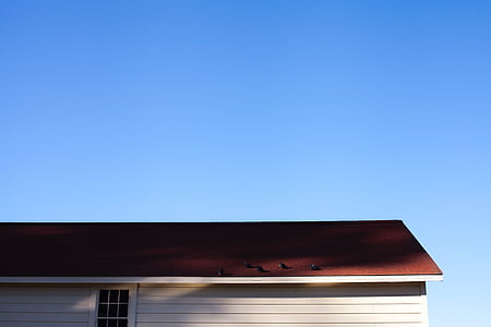maroon and white house under blue sky at daytime thumbnail