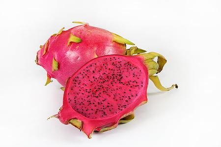 ripe dragon fruit sliced in half on white surface thumbnail
