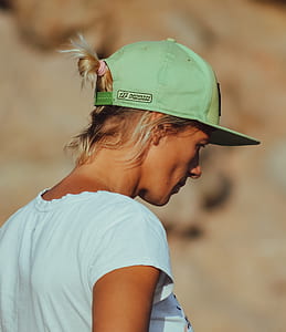 woman wearing green snap-back cap and teal cap-sleeved shirt thumbnail