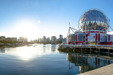 silver ball building beside body of water thumbnail