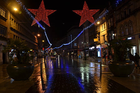 street with lights turned on at nighttime thumbnail