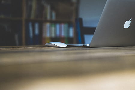 MacBook Air beside Apple Magic Mouse on table thumbnail