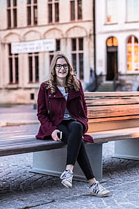 woman sitting on brown wooden bench thumbnail