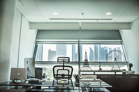 clear glass top table with silver MacBook near glass window thumbnail