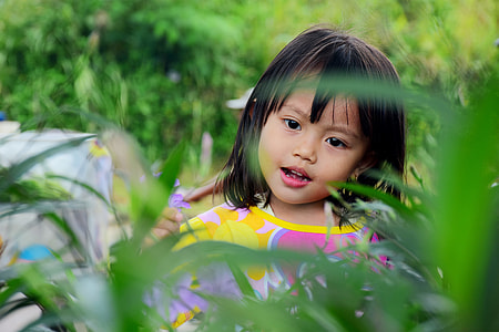 photo of girl wearing pink and yellow top looking grass thumbnail