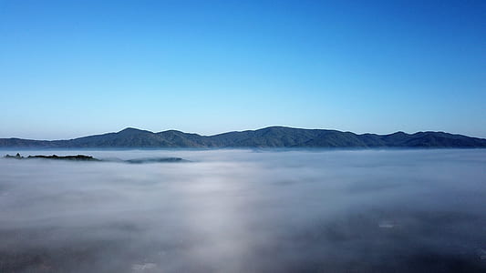 landscape photography of white cloud and mountain thumbnail