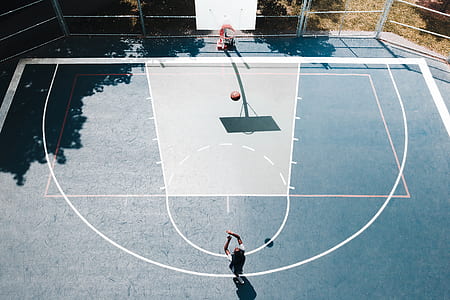 person playing basketball on a basketball court thumbnail