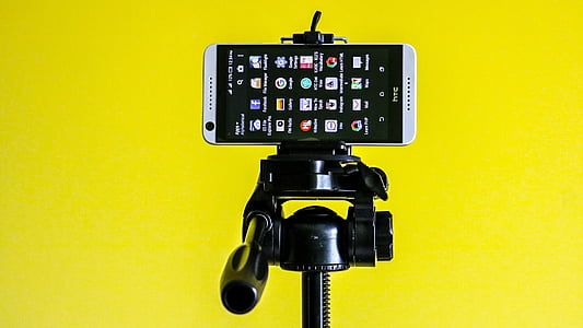 white HTC Desire 626 smartphone on camera stand thumbnail
