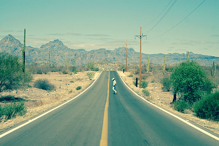 person wearing white shirt crossing gray concrete road thumbnail