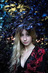 woman in red and black floral dress posing for picture thumbnail