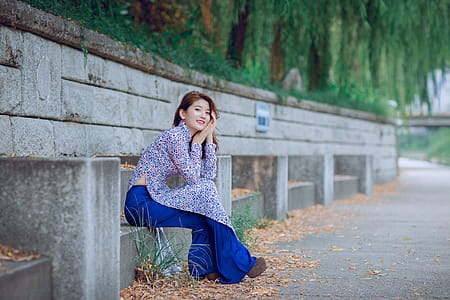Woman Sitting On Grey Concrete Chair thumbnail