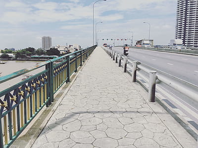 Person Riding on Motorcycle Passing by Concrete Pavement thumbnail