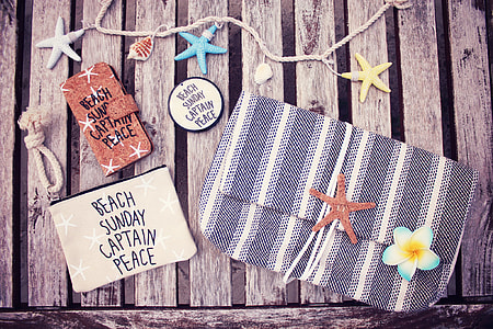 women's gray and white stripe clutch bag near star fish thumbnail