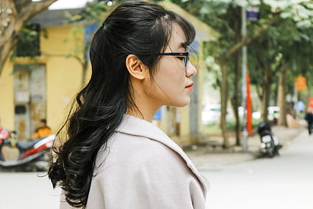 woman wearing white coat and eyeglasses at daytime thumbnail