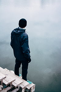 man standing on peak at daytime thumbnail