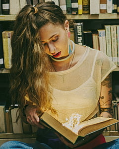 woman reading book in libraray thumbnail