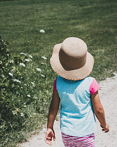 toddler's blue shirt standing beside plant thumbnail