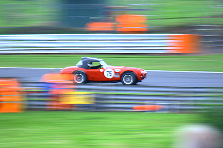 red and black 75 convertible coupe on race track at daytime thumbnail
