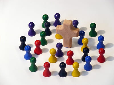 flat lay photography of multicolored ball-head piece lot and brown wooden cross thumbnail